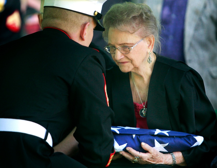 Dorothy Sobczak, Cpl. Harold W. Reed's wife at the time of his death 63 years ago, is presented with a folded American flag to honor her ex-husband's service to America at Reed's funeral service held at Ottawa Hills Memorial Park in Toledo, Ohio, on Saturday, May 24, 2014. Reed was killed during the Chosin Reservoir conflict in the Korean War and his body has been unidentified until recently. With his remains identified, Reed was finally brought back home and laid to rest with his loved ones in Toledo, 63 years after his death. (ISAAC HALE | STAFF PHOTOGRAPHER)