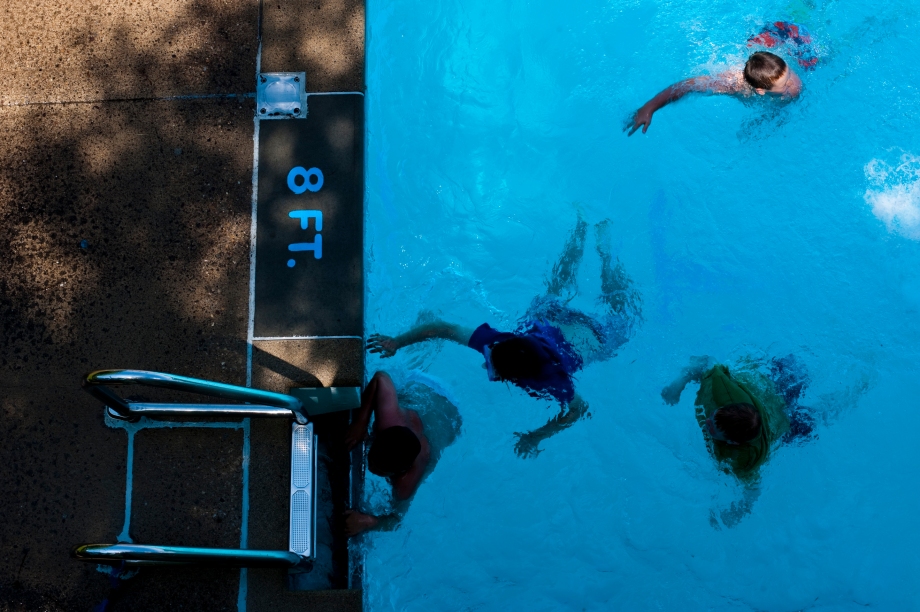 Janson Sauer, 9, top, swims towards the ladder at the South Park Wave Pool on Sunday, June 1, 2014. Despite the high temperature and humidity, the wave pool was not as crowded as it usually is on weekends. (EMILY HARGER | PHOTO EDITOR)