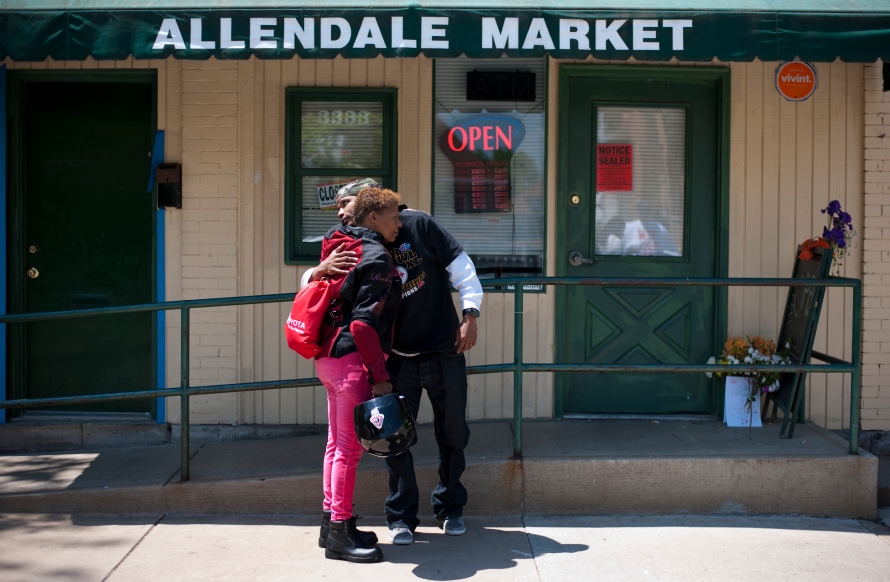 Eric Lee, landlord of the building that holds Allendale Market where  a fatal shooting took place the day before, hugs his mother Nadine Spradley outside of the market in Sheradon, Pennsylvania on May 19, 2014. Darryl Terry, the owner of Allendale Market, was fatally shot yesterday in his store. (EMILY HARGER | PHOTO EDITOR)